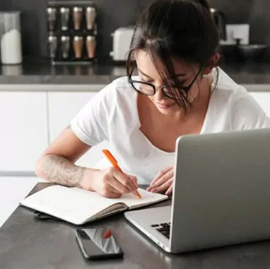 A Girl is Writting on NoteBook